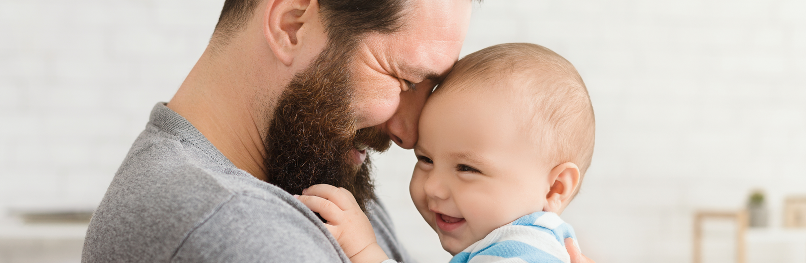 Dad holding smiling baby