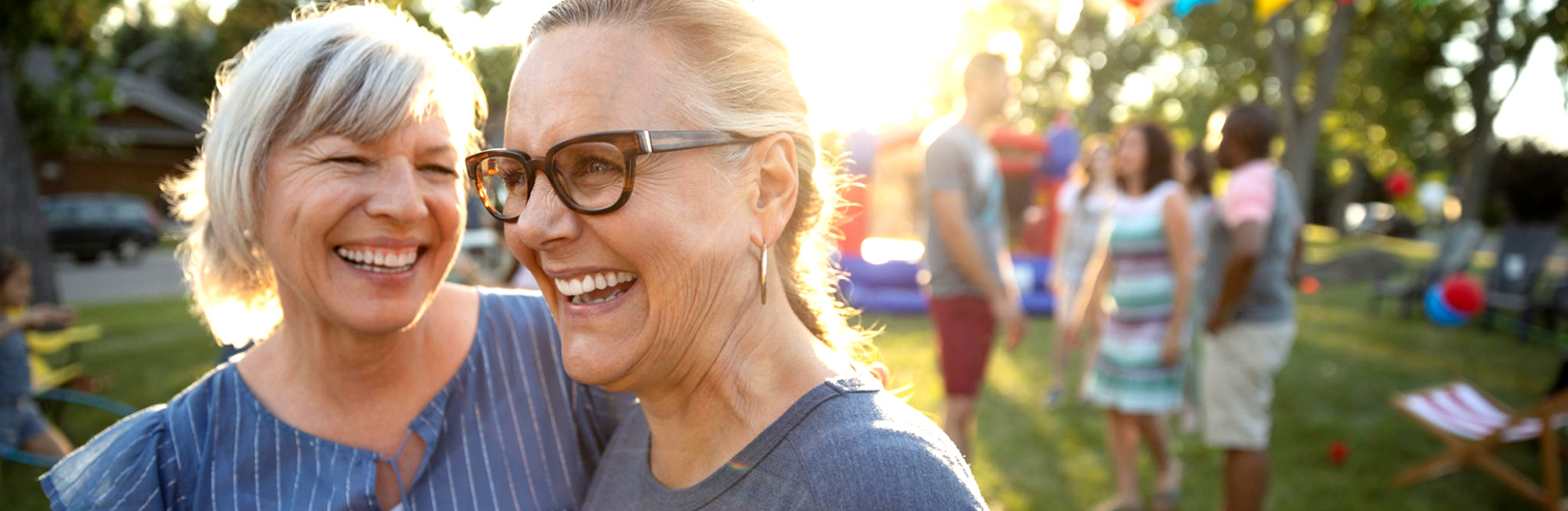 Happy, carefree senior women friends at summer neighborhood block party in park