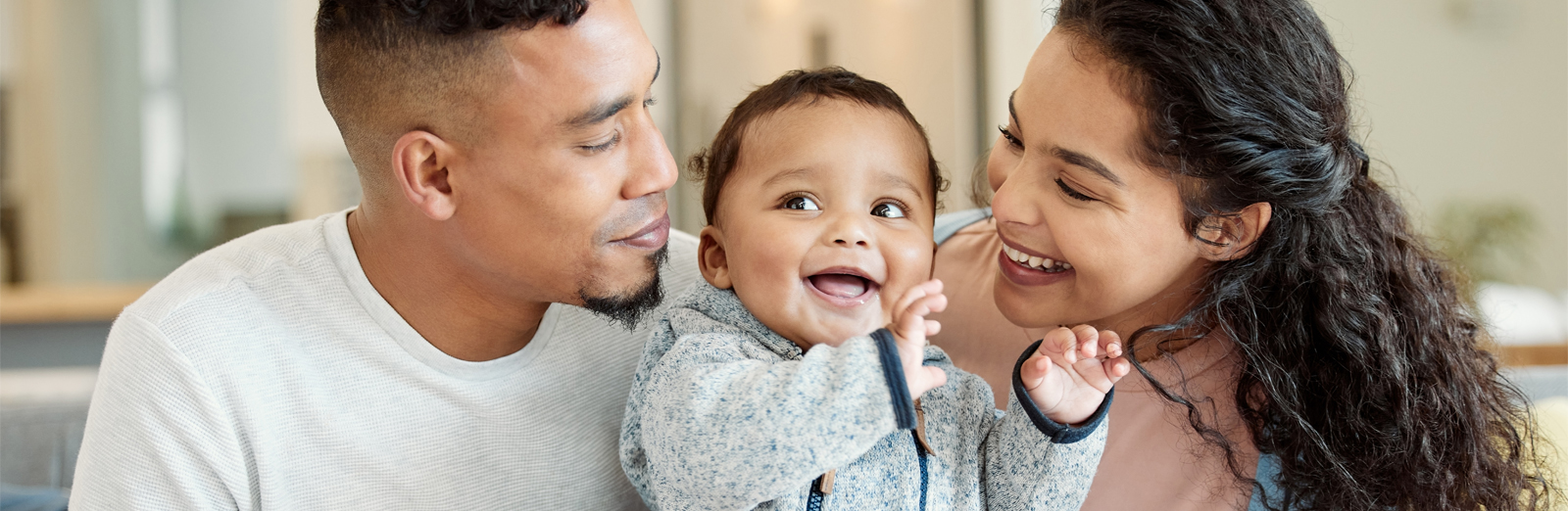 Young parents with a smiling baby