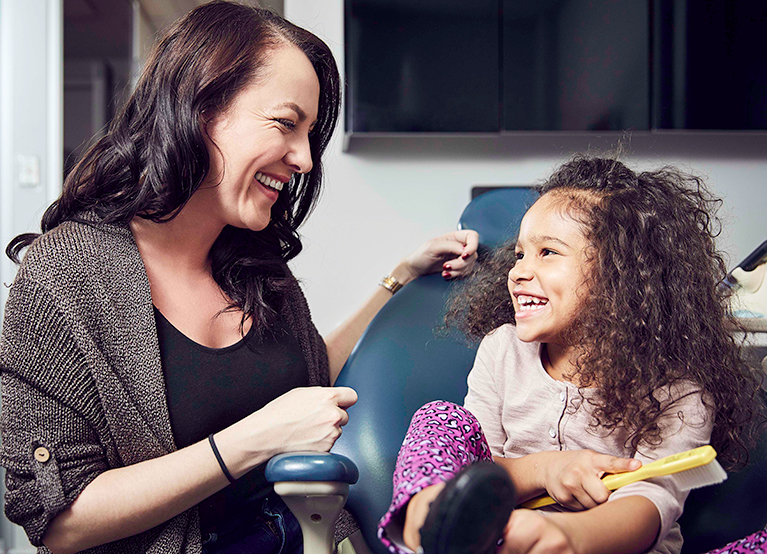 Smiling-mom-and-daughter-at-dentist_767x554.jpg