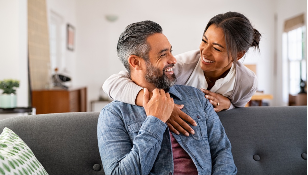 Mature multi-ethnic couple looking at each other and smiling. 