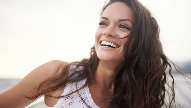 Smiling young woman at beach